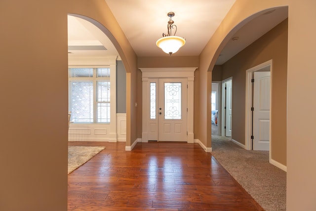 315 W Proctor St, Sturgeon, MO 65284 - entrance foyer with arched walkways, wood finished floors, and wainscoting