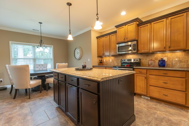 315 W Proctor St, Sturgeon, MO 65284 - kitchen with stainless steel appliances, crown molding, tasteful backsplash, a center island, and brown cabinets