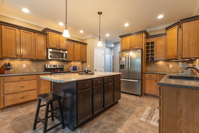 315 W Proctor St, Sturgeon, MO 65284 - kitchen with stainless steel appliances, a kitchen island, ornamental molding, brown cabinets, and decorative backsplash