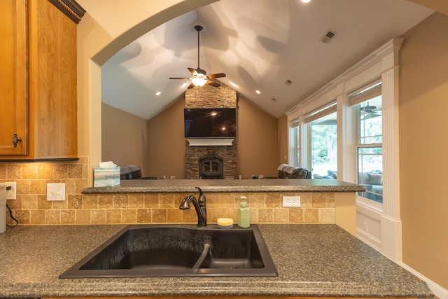 315 W Proctor St, Sturgeon, MO 65284 - kitchen with dark countertops, backsplash, a ceiling fan, open floor plan, and a fireplace
