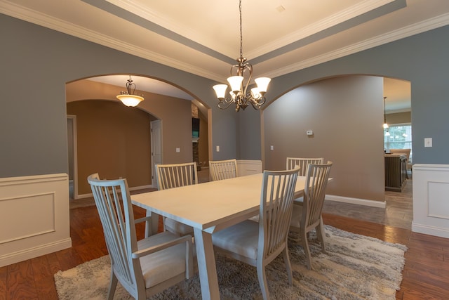 315 W Proctor St, Sturgeon, MO 65284 - dining room featuring arched walkways, wainscoting, wood finished floors, ornamental molding, and a chandelier