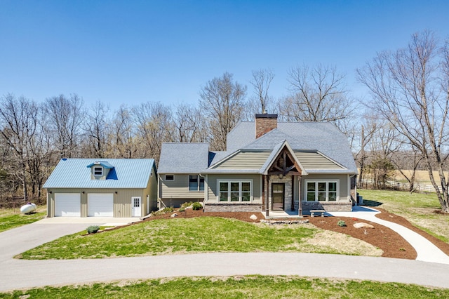 8900 W Graham Rd, Rocheport, MO 65279 - view of front of property with concrete driveway, a front yard, a garage, and a chimney