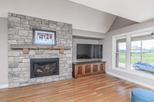 8900 W Graham Rd, Rocheport, MO 65279 - living room featuring wood finished floors, lofted ceiling, and a fireplace