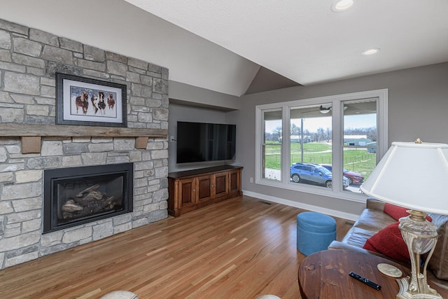8900 W Graham Rd, Rocheport, MO 65279 - living room featuring lofted ceiling, wood finished floors, and a fireplace