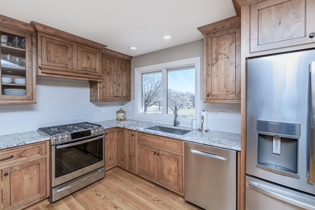 8900 W Graham Rd, Rocheport, MO 65279 - kitchen with appliances with stainless steel finishes, light wood-style floors, backsplash, light stone counters, and recessed lighting