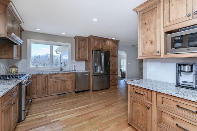 8900 W Graham Rd, Rocheport, MO 65279 - kitchen featuring stainless steel appliances, backsplash, light wood-style flooring, light stone countertops, and recessed lighting