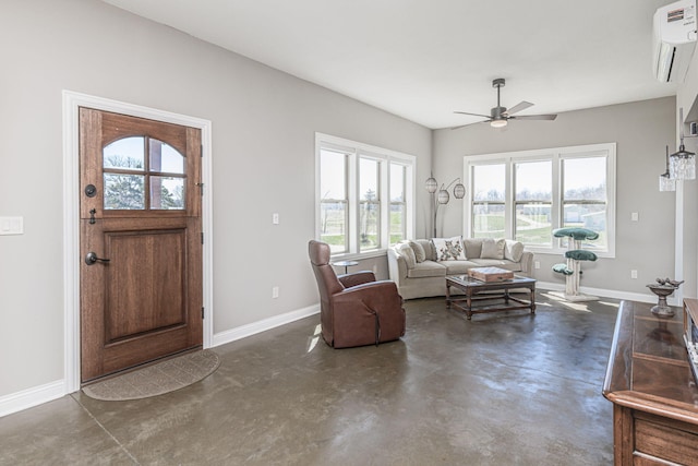 8900 W Graham Rd, Rocheport, MO 65279 - living area with a wall mounted air conditioner, concrete floors, and a ceiling fan
