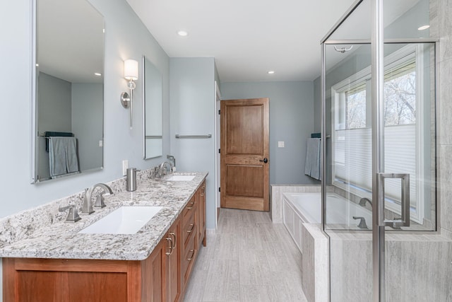 8900 W Graham Rd, Rocheport, MO 65279 - bathroom with double vanity, a garden tub, and recessed lighting