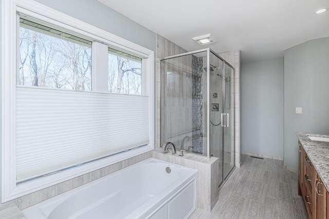8900 W Graham Rd, Rocheport, MO 65279 - bathroom with vanity, a garden tub, and a stall shower