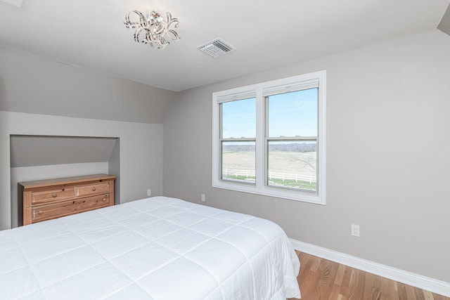 8900 W Graham Rd, Rocheport, MO 65279 - bedroom with wood finished floors and vaulted ceiling