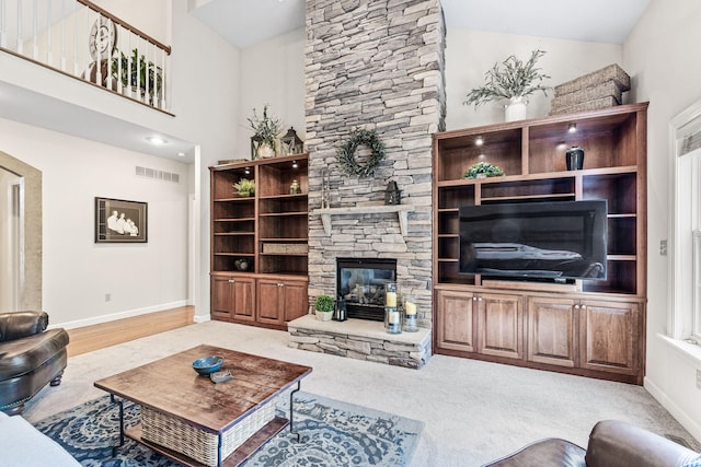 1707 Brookfield Mnr, Columbia, MO 65203 - living area featuring a stone fireplace, carpet, and a high ceiling