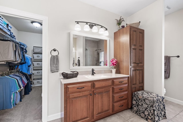 1707 Brookfield Mnr, Columbia, MO 65203 - bathroom featuring vanity, tiled shower, tile patterned flooring, and a spacious closet