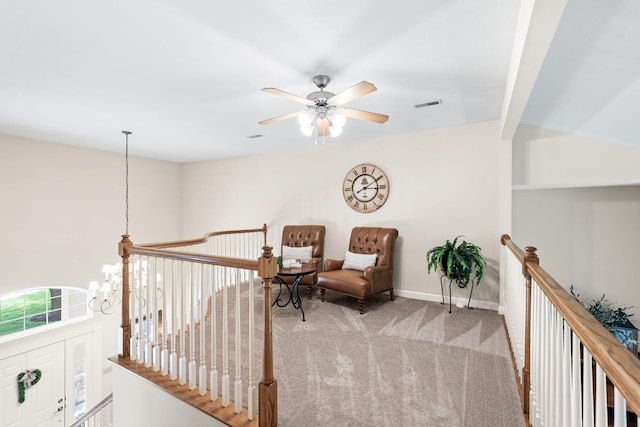 1707 Brookfield Mnr, Columbia, MO 65203 - living area featuring an upstairs landing, carpet, a chandelier, and a ceiling fan