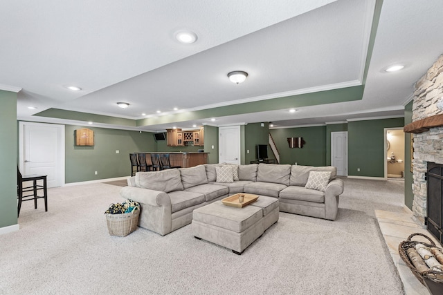 1707 Brookfield Mnr, Columbia, MO 65203 - carpeted living room featuring a tray ceiling, ornamental molding, bar area, a stone fireplace, and recessed lighting