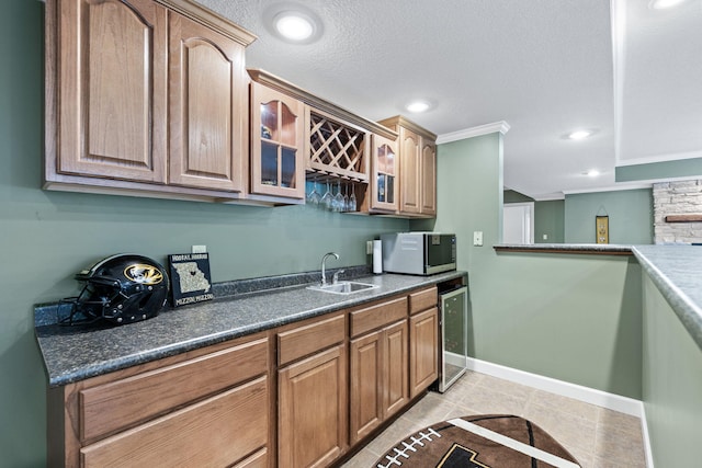 1707 Brookfield Mnr, Columbia, MO 65203 - kitchen with beverage cooler, stainless steel microwave, glass insert cabinets, dark countertops, and light tile patterned floors