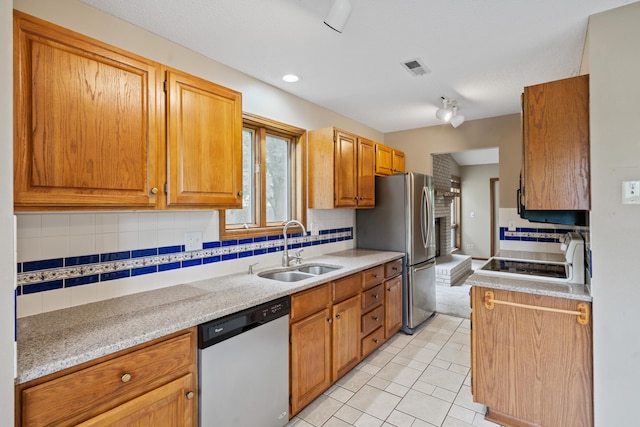 2002 Chapel Hill Rd, Columbia, MO 65203 - kitchen featuring appliances with stainless steel finishes, tasteful backsplash, light tile patterned floors, light stone counters, and recessed lighting