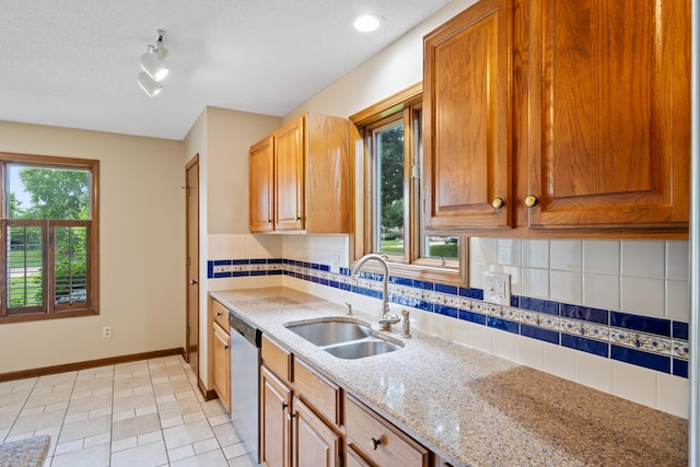 2002 Chapel Hill Rd, Columbia, MO 65203 - kitchen with dishwasher, light stone countertops, tasteful backsplash, track lighting, and light tile patterned floors
