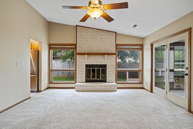 2002 Chapel Hill Rd, Columbia, MO 65203 - unfurnished living room with lofted ceiling, carpet floors, healthy amount of natural light, ceiling fan, and a brick fireplace