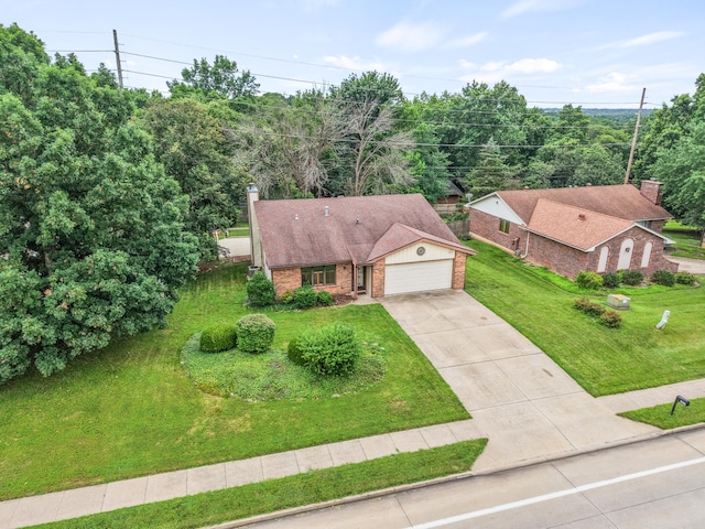 2002 Chapel Hill Rd, Columbia, MO 65203 - view of front of property featuring brick siding, concrete driveway, an attached garage, a front yard, and a chimney