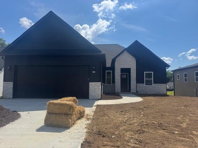 410 Sugarberry Dr, Columbia, MO 65201 - view of front of home featuring stone siding, driveway, and an attached garage