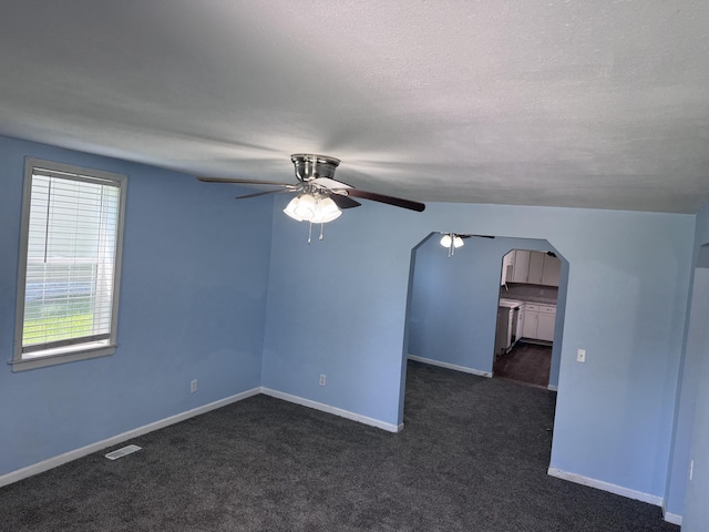 809 S 4th St, Moberly, MO 65259 - unfurnished room featuring a ceiling fan, arched walkways, and dark carpet