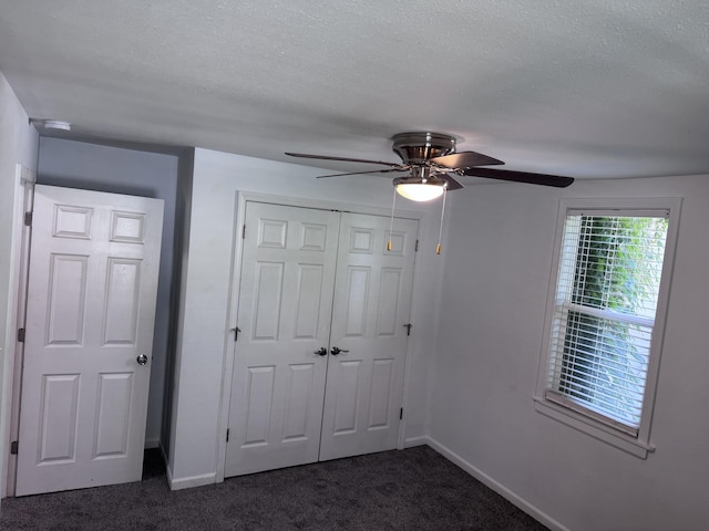 809 S 4th St, Moberly, MO 65259 - unfurnished bedroom with dark colored carpet, a closet, ceiling fan, and a textured ceiling