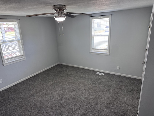 809 S 4th St, Moberly, MO 65259 - empty room featuring a textured ceiling, a ceiling fan, and dark carpet