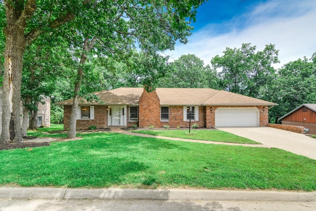 1745 Engelwood Dr, Jefferson City, MO 65101 - ranch-style house featuring an attached garage, driveway, a front lawn, and brick siding