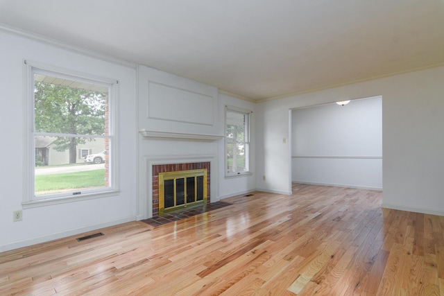 1745 Engelwood Dr, Jefferson City, MO 65101 - unfurnished living room with healthy amount of natural light, light wood-type flooring, a brick fireplace, and ornamental molding