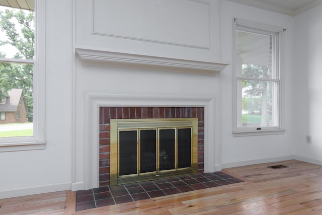 1745 Engelwood Dr, Jefferson City, MO 65101 - detailed view of ornamental molding, a fireplace, and wood finished floors