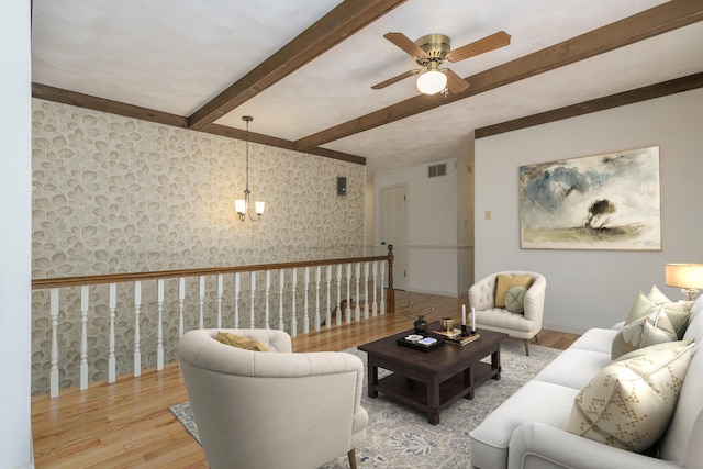 1745 Engelwood Dr, Jefferson City, MO 65101 - living area with wood finished floors, beam ceiling, wallpapered walls, and ceiling fan