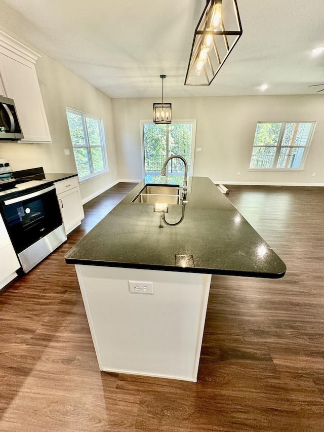 1680 W Fenton Rd, Columbia, MO 65202 - kitchen with electric range oven, stainless steel microwave, dark wood-style flooring, and white cabinetry