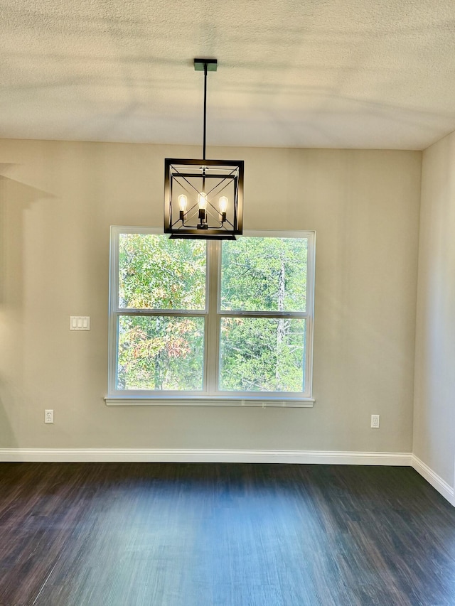 1680 W Fenton Rd, Columbia, MO 65202 - empty room featuring a chandelier, dark wood-style flooring, and a textured ceiling