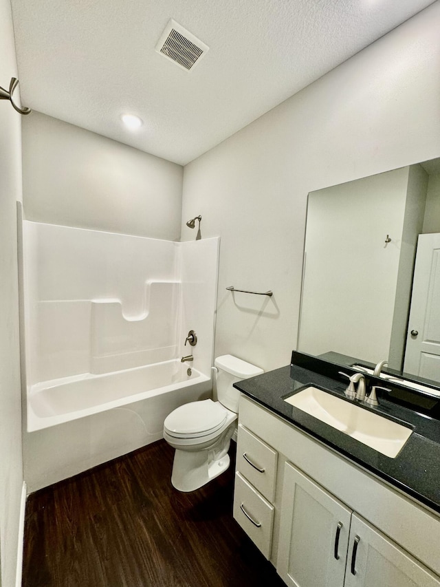 1680 W Fenton Rd, Columbia, MO 65202 - bathroom with wood finished floors, vanity, shower / tub combination, and a textured ceiling