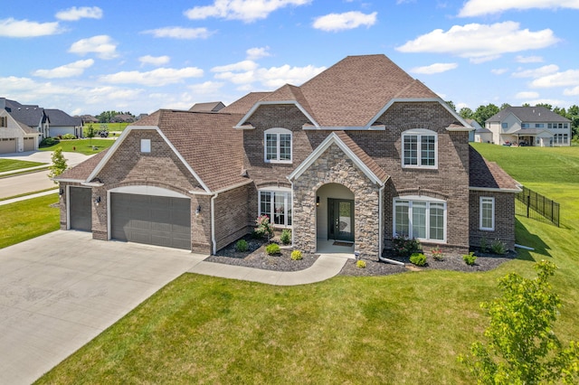 2821 Clopton Ct, Columbia, MO 65203 - french country home with an attached garage, driveway, brick siding, and a front yard