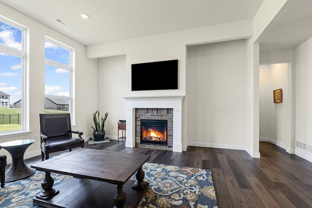 2821 Clopton Ct, Columbia, MO 65203 - living room featuring a glass covered fireplace, dark wood finished floors, and recessed lighting