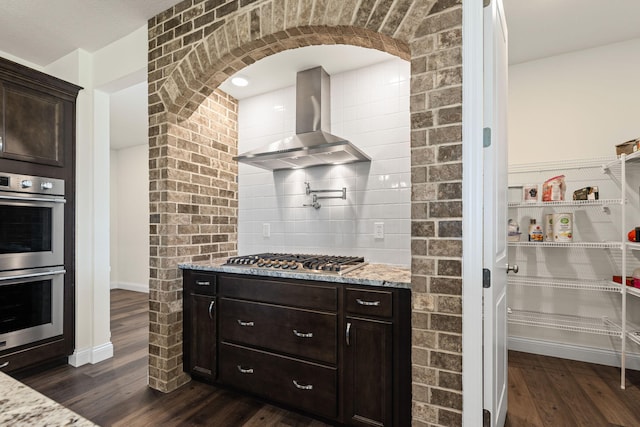 2821 Clopton Ct, Columbia, MO 65203 - kitchen with stainless steel appliances, wall chimney exhaust hood, dark wood-style floors, and light stone counters