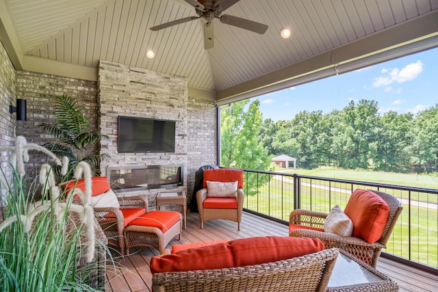 1107 Marcassin Dr, Columbia, MO 65201 - deck with ceiling fan, an outdoor living space with a fireplace, and view of wooded area
