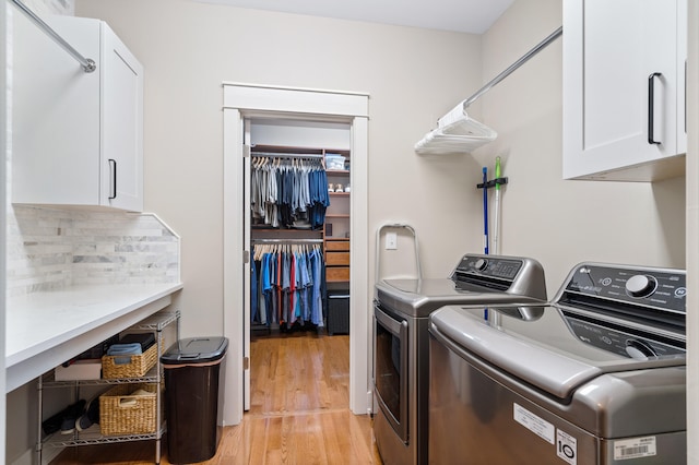 1107 Marcassin Dr, Columbia, MO 65201 - laundry area with cabinet space, washing machine and clothes dryer, and light wood-style flooring
