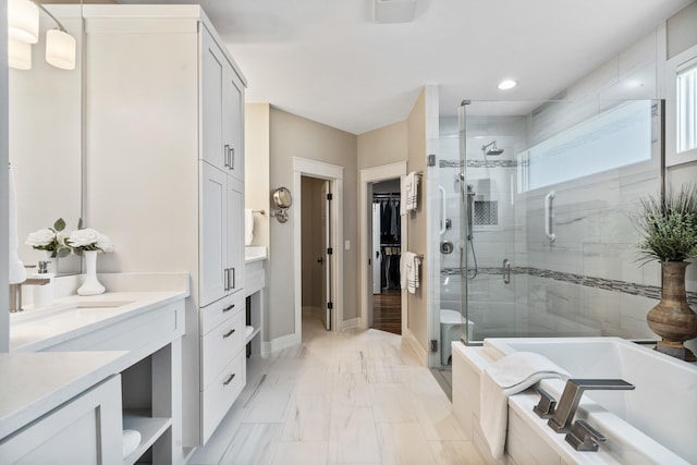 1107 Marcassin Dr, Columbia, MO 65201 - bathroom featuring a stall shower, a garden tub, vanity, a spacious closet, and recessed lighting