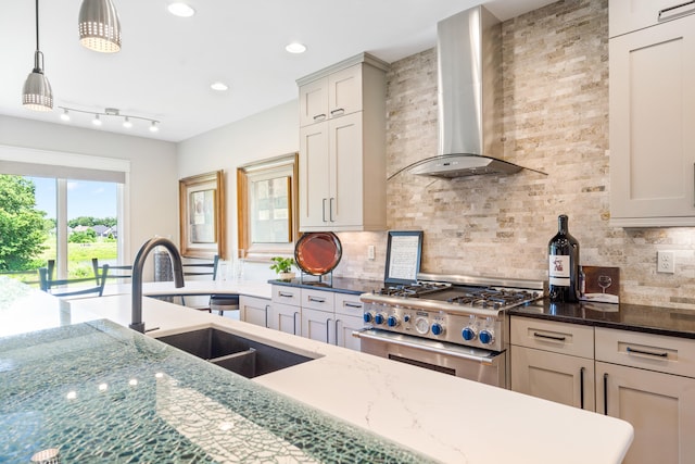 1107 Marcassin Dr, Columbia, MO 65201 - kitchen featuring stainless steel range, wall chimney range hood, decorative backsplash, dark stone countertops, and decorative light fixtures