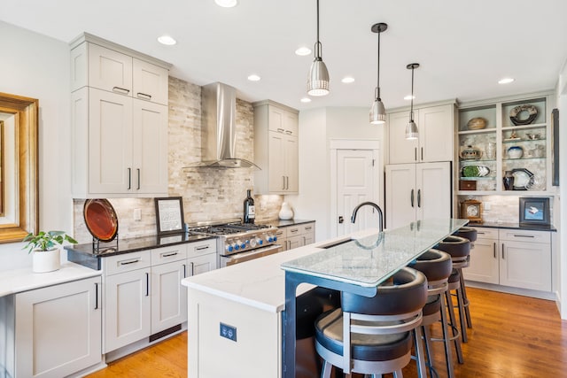 1107 Marcassin Dr, Columbia, MO 65201 - kitchen with wall chimney range hood, high end stainless steel range oven, tasteful backsplash, recessed lighting, and light stone countertops