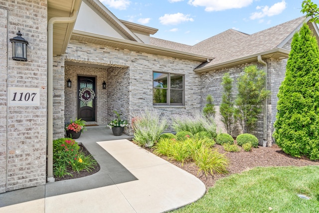 1107 Marcassin Dr, Columbia, MO 65201 - property entrance with a shingled roof, stone siding, and brick siding