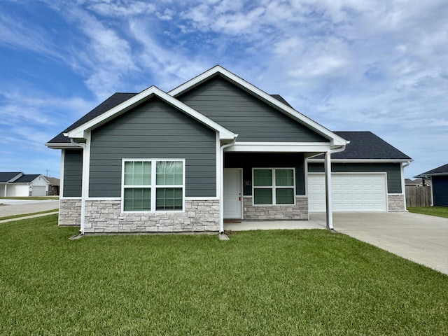 921 S Columbia St, Centralia, MO 65240 - view of front of home featuring stone siding, an attached garage, concrete driveway, and a front lawn
