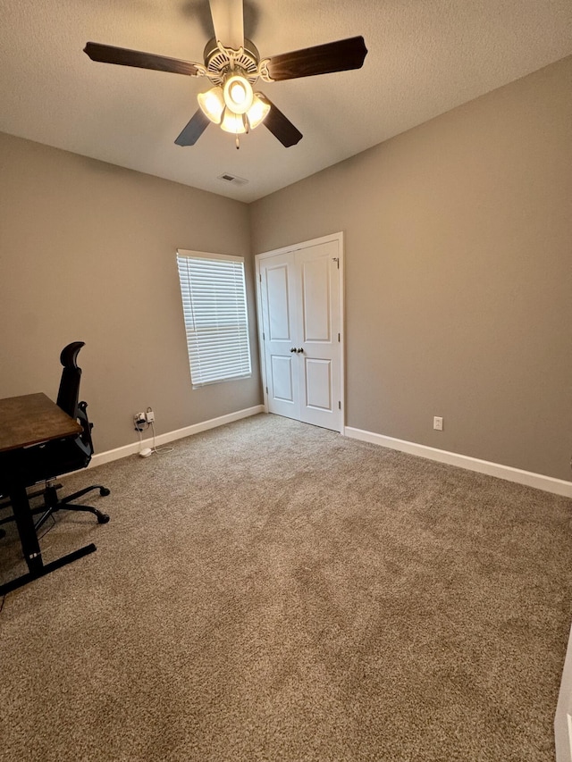 921 S Columbia St, Centralia, MO 65240 - unfurnished office featuring carpet floors, a ceiling fan, and a textured ceiling