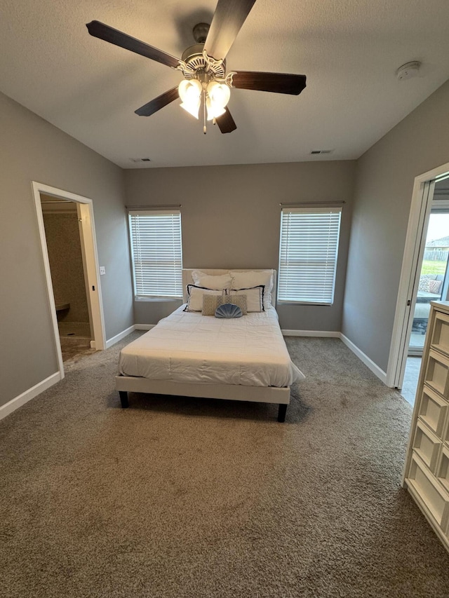 921 S Columbia St, Centralia, MO 65240 - carpeted bedroom with a textured ceiling, ceiling fan, and connected bathroom