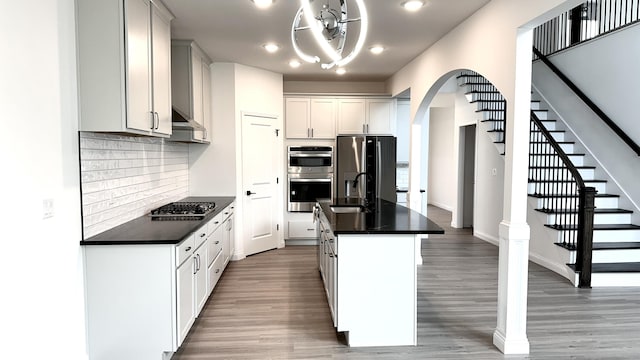 717 Angels Rest Way, Columbia, MO 65203 - kitchen featuring dark countertops, stainless steel appliances, recessed lighting, arched walkways, and tasteful backsplash