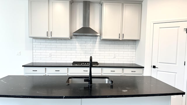 717 Angels Rest Way, Columbia, MO 65203 - kitchen featuring wall chimney exhaust hood, stainless steel gas cooktop, tasteful backsplash, and dark stone counters
