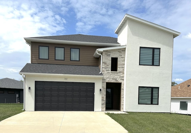 717 Angels Rest Way, Columbia, MO 65203 - contemporary house featuring driveway, an attached garage, a front yard, and stucco siding