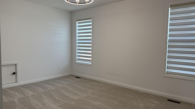 717 Angels Rest Way, Columbia, MO 65203 - unfurnished room featuring a chandelier, carpet floors, and plenty of natural light